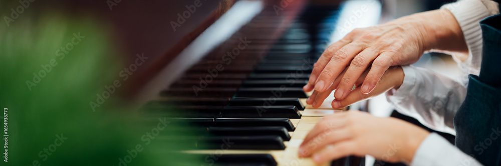 Fototapeta premium Hands Playing Piano Wide Banner with Copy Space