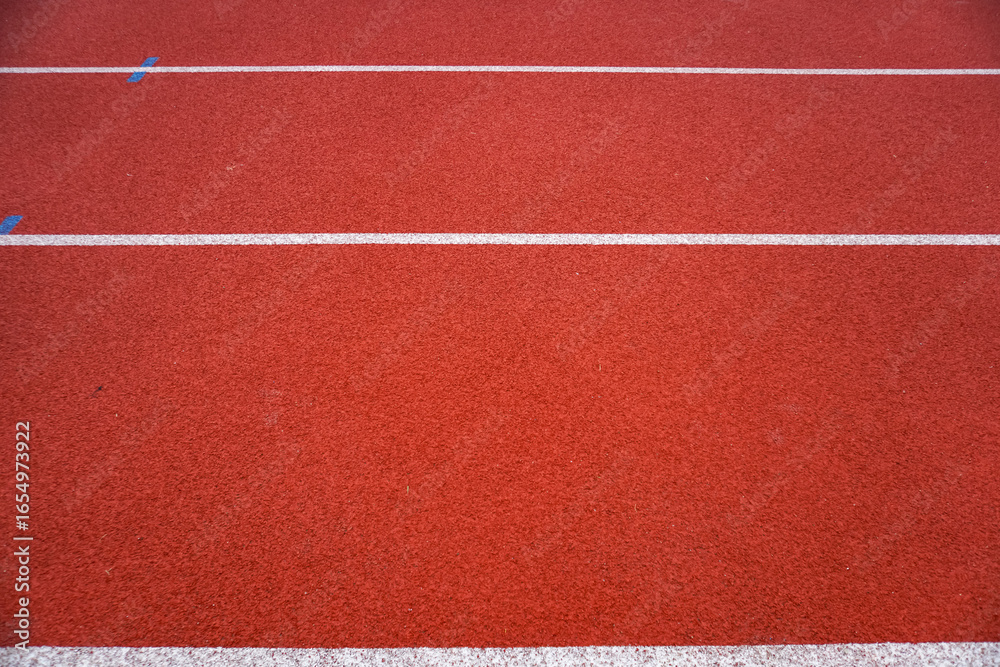 Fototapeta premium Red running track for athletics at the stadium. Stadium for running and other sports.