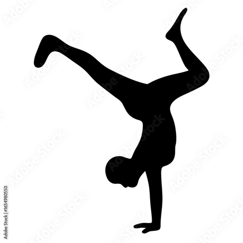 Silhouette of a person doing a handstand with legs in the air