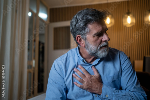 Εκτύπωση καμβά Mature man with sudden chest pain at home in the evening suffering from possible