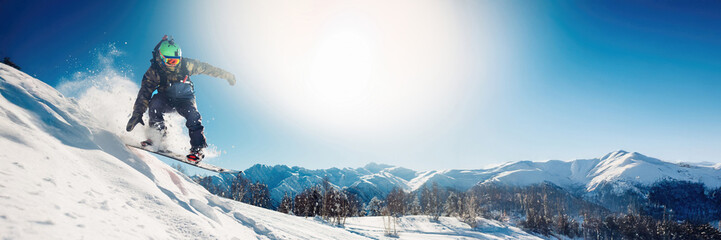 Snowboarder Jumping on Mountain Wide Banner