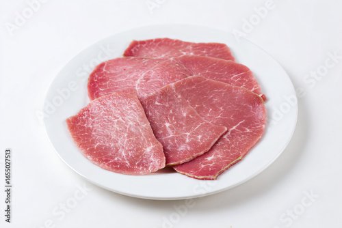 a plate of meat on a white table