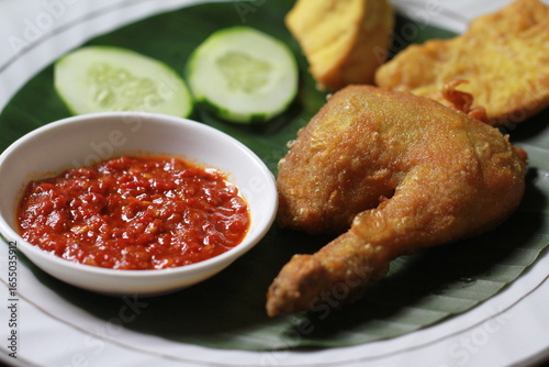 Indonesian fried chicken with sambal red chili, tofu,cucumber and tempe
