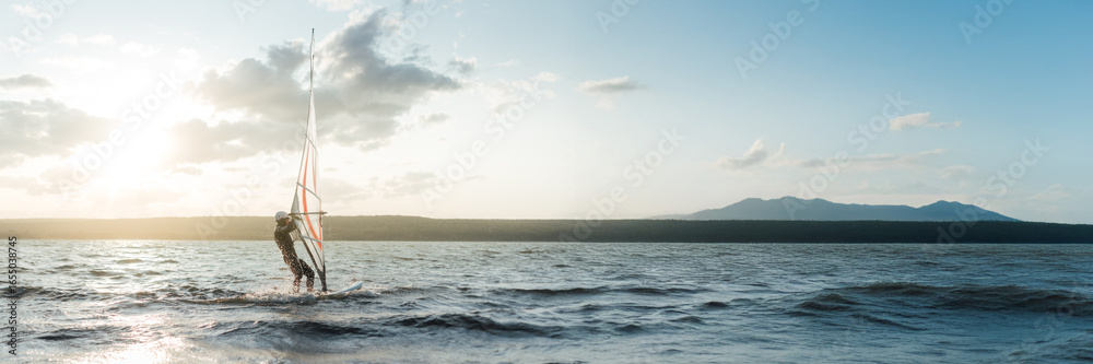 Naklejka premium Windsurfing at Sunset Wide Banner with Copy Space