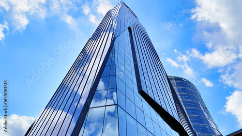 Modern sustainable glass office buildings. Exterior view of corporate headquarters glass buildings architecture.Glass windows in energy-efficient buildings. Financial business center buildings. 