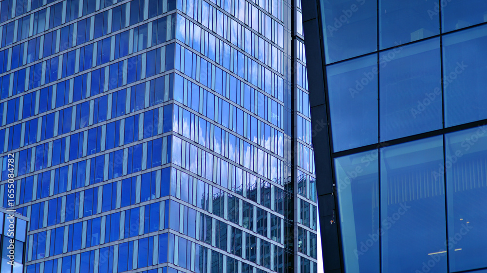 Fototapeta premium Modern sustainable glass office buildings. Exterior view of corporate headquarters glass buildings architecture.Glass windows in energy-efficient buildings. Financial business center buildings. 