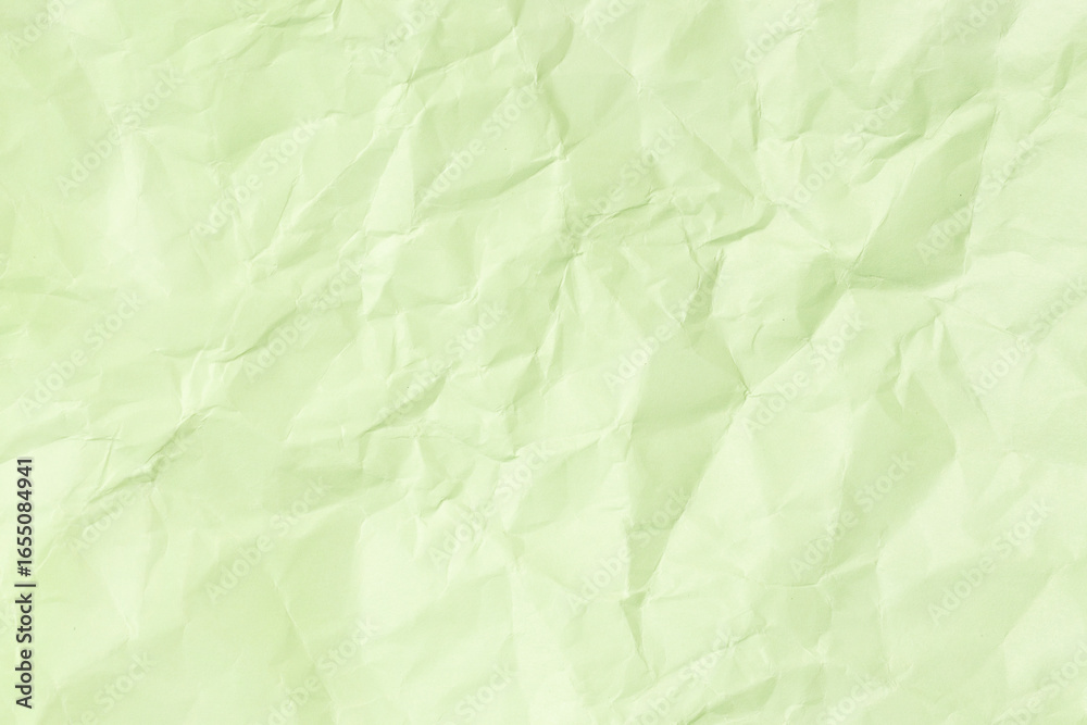 Obraz premium Green crumpled paper background texture. Full frame