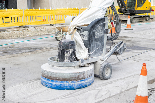 Grinding machine working on Concrete city road on construction site
