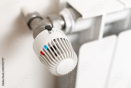 Heating Radiator with turn off position thermostat. Energy crisis concept