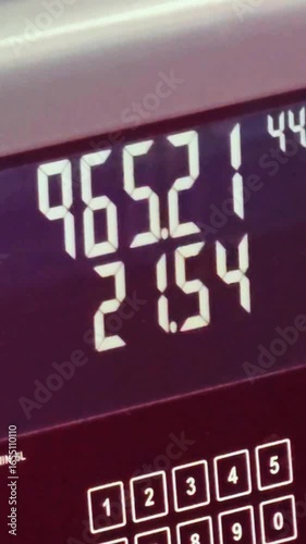 Gas station fuel meter counter price. Close up while refueling a car. Close-up of petrol station with running numbers on gas pump. 