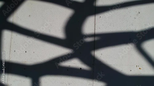 Abstract Geometric Shadows Shifting Across Textured Concrete Wall Surface