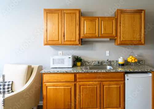 фотографія Compact Studio Kitchenette with Wood Cabinets and Granite Countertop