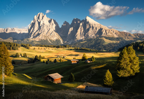 Sunset Mountain Landscape in Autumn at Alpe di Siusi (Seiser Alm) in the Dolomites, Italy. Epic Landscape with Huts, Meadows and Mountains at Sunset.