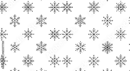Seamless pattern of various handdrawn black snowflakes with intricate sketchy designs.
