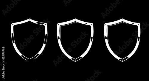 Set of three white handdrawn shield outlines with a sketchy chalklike texture Heraldic emblem icons.