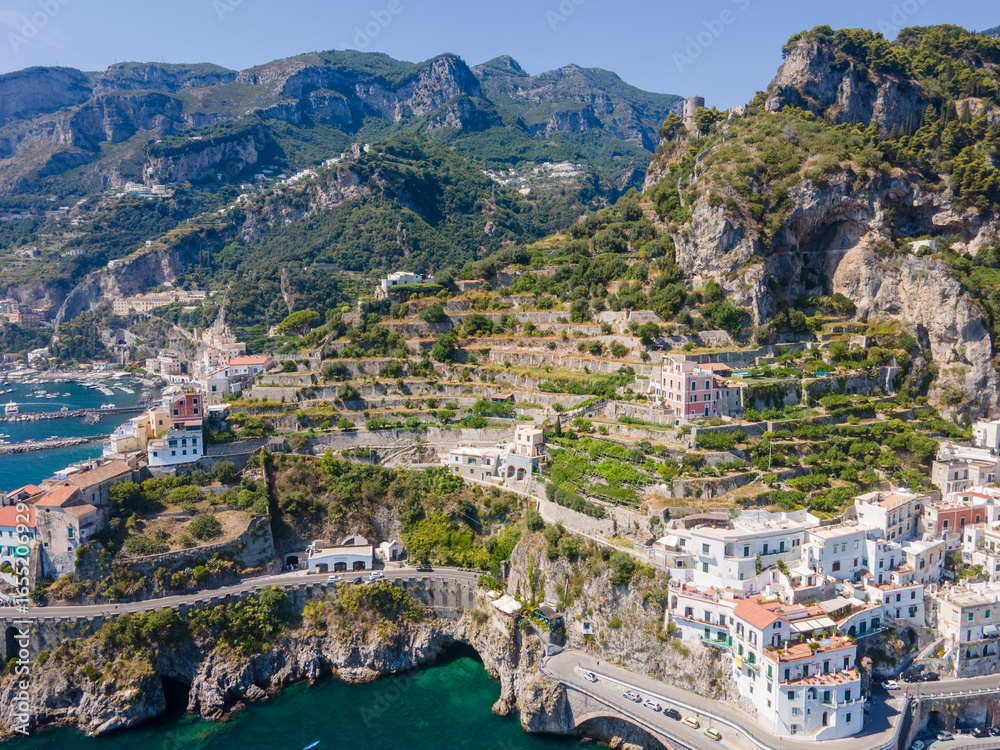 Naklejka premium Aerial cliff landscape of Amalfi Coast village on Mediterranean Sea during summer in Campania