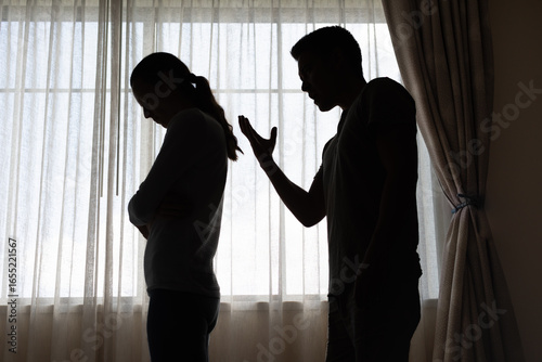 Фотография unhappy crying frightened woman, aggressive man quarreling at home