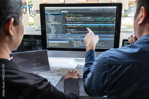 Team of developer programmer working on project in software development computer in IT company office, Writing codes and data code website and coding database technologies to find problem solution