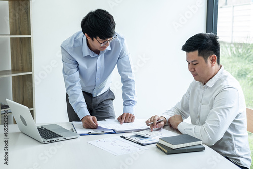 Two business partner team meeting and discussion financial project of investment ideas, presentation and analyzing marketing planning strategy of business making to growth profit and successful