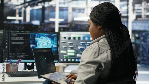 Tableau sur toile Server room IT expert using laptop to apply artificial intelligence technology minimizing system downtime