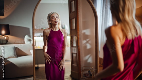 Bild auf Leinwand Blonde trying party dress planning outfit gazing reflection
