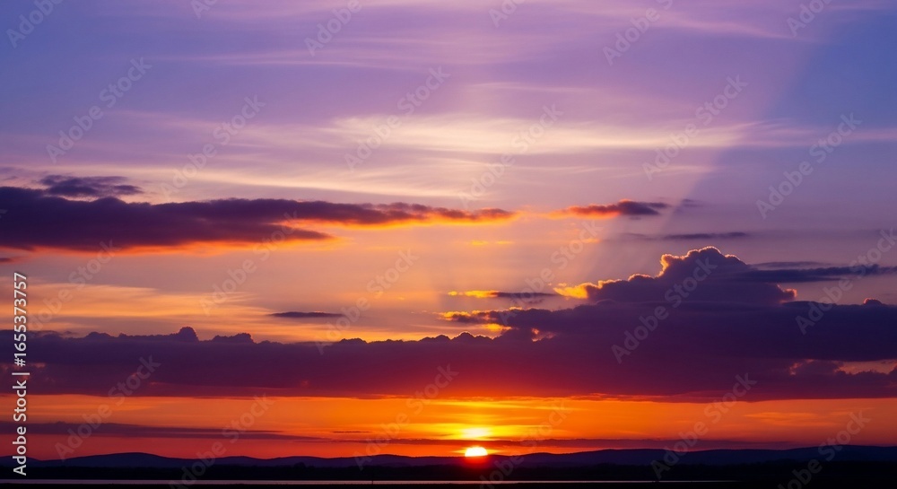 Vivid Purple and Orange Sunset Sky with Radiant Sun and Dark Cloud Formations Vivid Purple and Orange Sunset Sky with Radiant Sun and Dark Cloud Formations