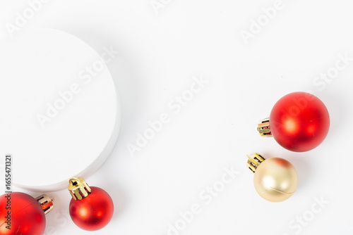 A white background with a red and gold ball and a red ball