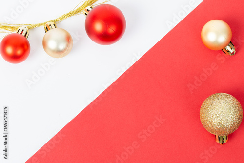 A red and white background with a row of red and gold ornaments