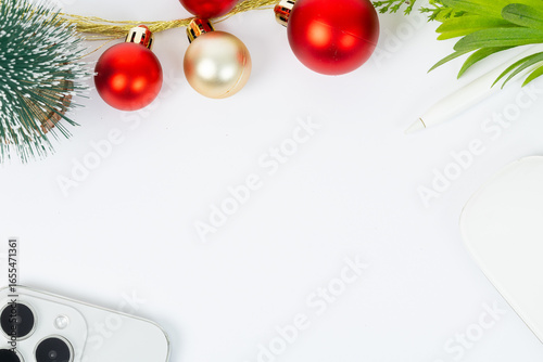 A white background with a Christmas tree and red and gold ornaments