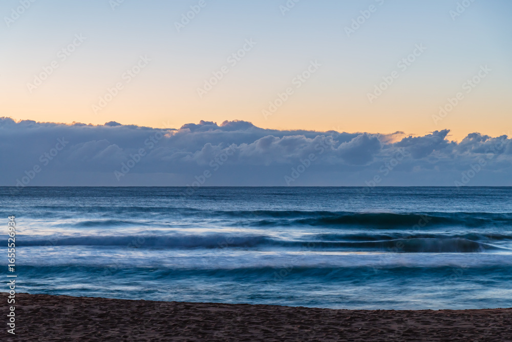 Fototapeta premium Sunrise by the sea shore