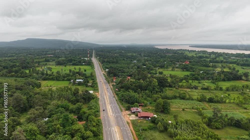Drone video of transportation and communication infrastructure in the Thai countryside, with a highway and cell tower.