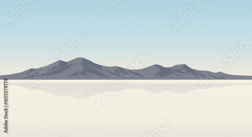 Stark gray mountains stretch across a pale backdrop with a blurred reflection below