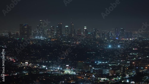 Wallpaper Mural Timelapse drone view of Los Angeles at night, with glowing skyscrapers and bustling streets. A dynamic aerial sweep captures the city’s electric energy, iconic skyline, and cinematic urban pulse. Torontodigital.ca