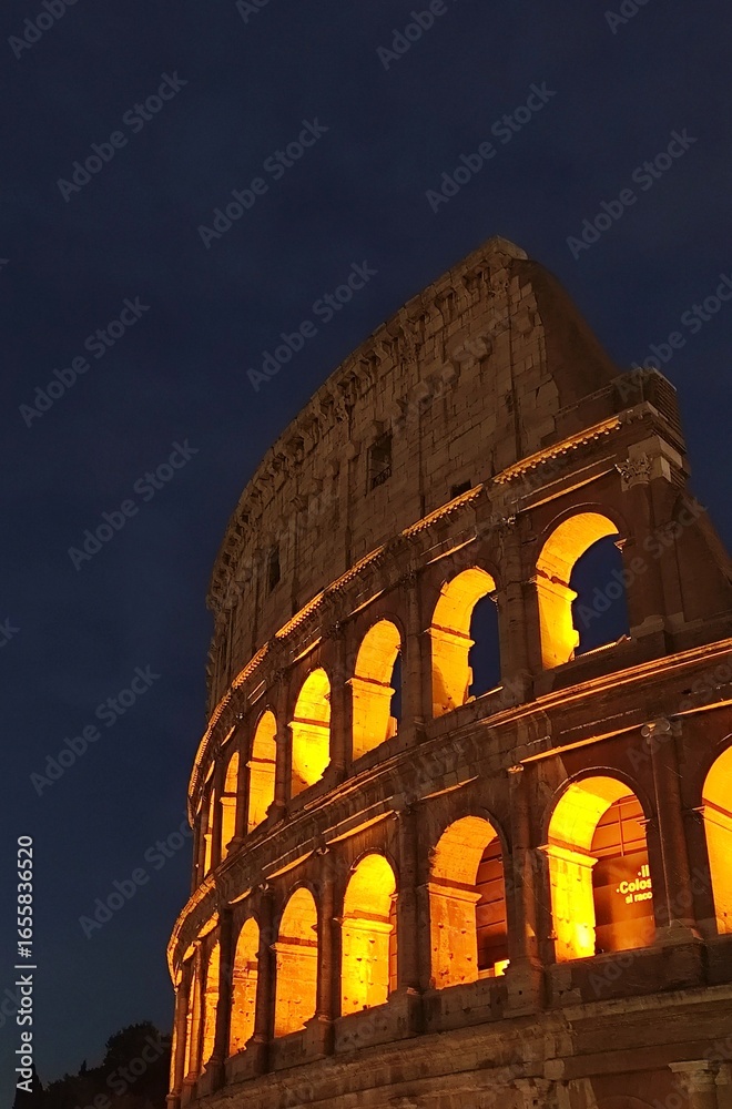 Fototapeta premium Colosseum at night in Rome, Italy. Famous landmark