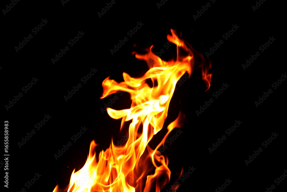 Obraz premium Close up burning flames on black background for graphic design or wallpaper.