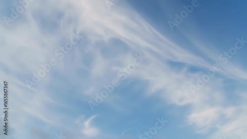 Wispy clouds drift across a vibrant blue sky