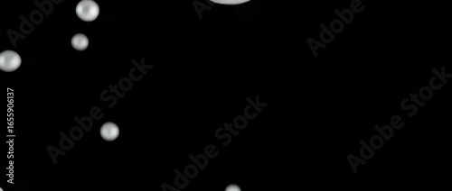 Explosion of water droplets into the camera in slow motion on an isolated black background, 4K Video