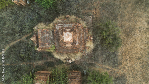 Aerial view of ancient temple ruins, weathered and overgrown with dry grasses, stand as silent sentinels in the arid landscape, Old Bagan, Mandalay Region, Myanmar (Burma).