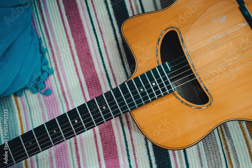 Photography Gypsy jazz acoustic guitar on a colorful blanket