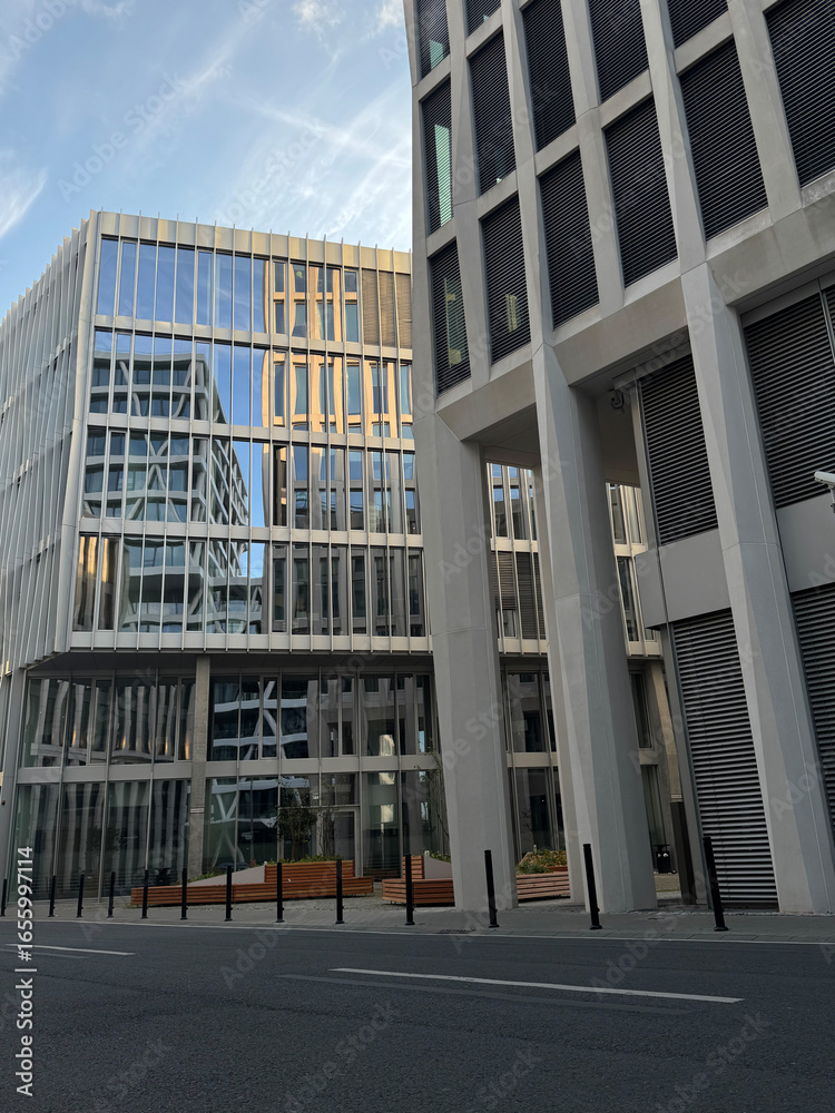 Fototapeta premium Modern Glass Office Buildings with Reflections in Urban Cityscape