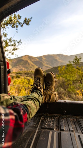 Relaxed feet resting in a truck bed, viewing a mountain landscape