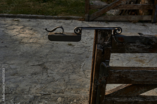 Fotografie wrought iron gate to close a wooden door on a property