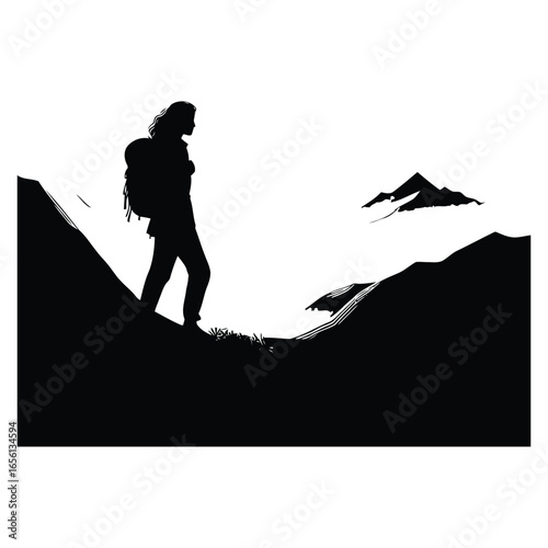 Silhouette of a hiker on a mountain ridge