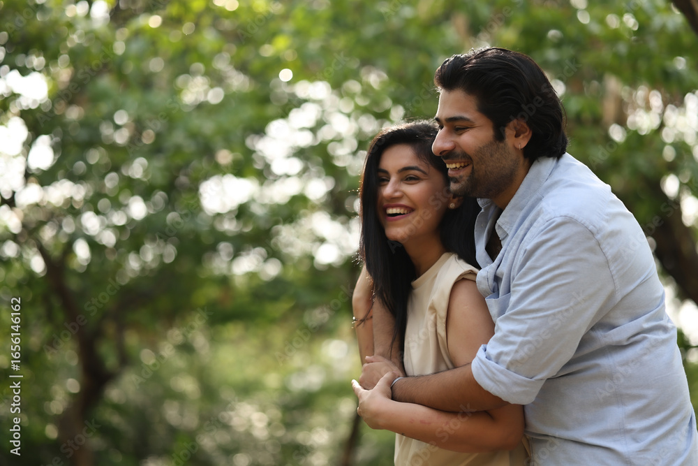 Fototapeta premium Couple Enjoys Playful Moment In Sunny Park Setting