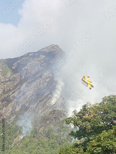 a canadair in action  on fire in the mountains