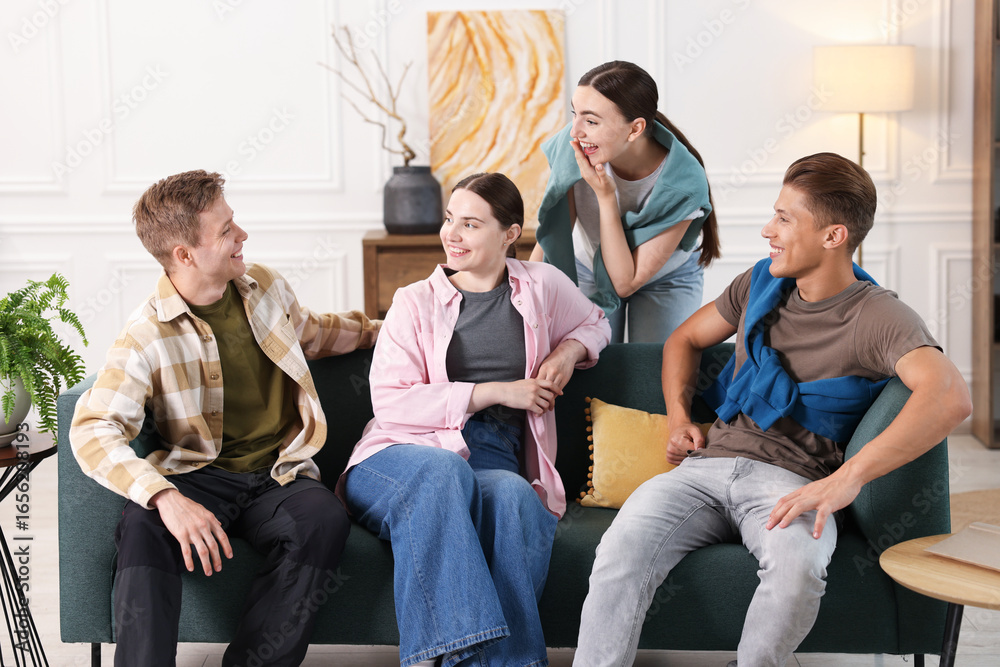 Fototapeta premium Friends laughing on sofa indoors. Positive emotion