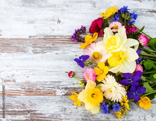 Vibrant flower arrangement on a weathered wooden surface