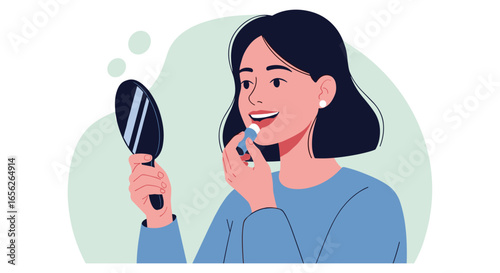 A young woman with dark hair applies lip balm while looking into a small handheld mirror, illustrating a daily beauty and self-care routine.