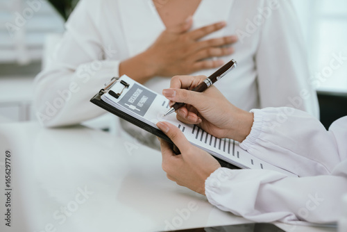 A doctor consults with a patient in a healthcare office, reviewing documents and providing medical advice, diagnosis, and treatment during a professional hospital or clinic appointment.