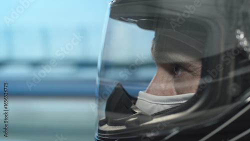 Professional racing driver speeding on track, close-up on eyes behind helmet visor, symbolizing precision, focus, competition, and high-speed action.